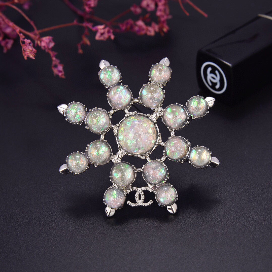 Chanel Winter Wonderland Silver Snowflake Opal-Effect Starburst CC Brooch
