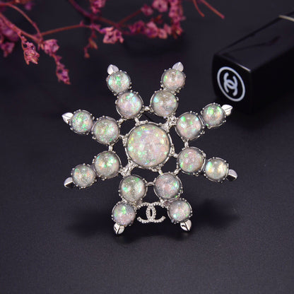Chanel Winter Wonderland Silver Snowflake Opal-Effect Starburst CC Brooch