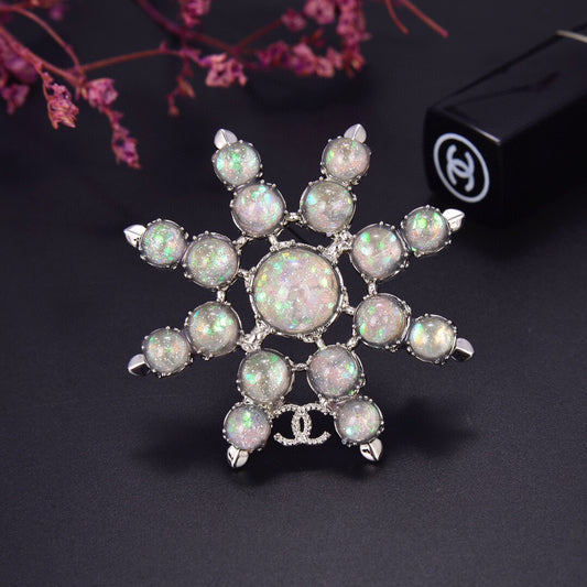 Chanel Winter Wonderland Silver Snowflake Opal-Effect Starburst CC Brooch